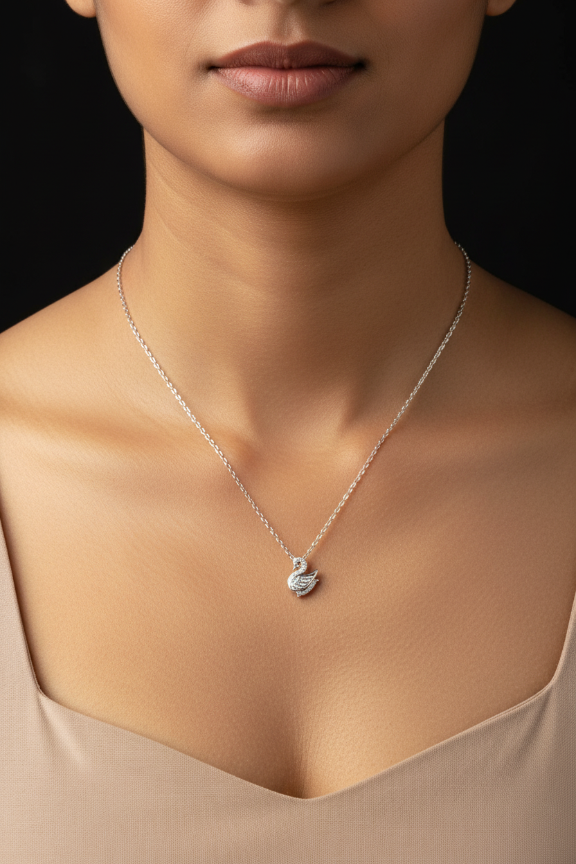 Silver swan pendant necklace on a black background