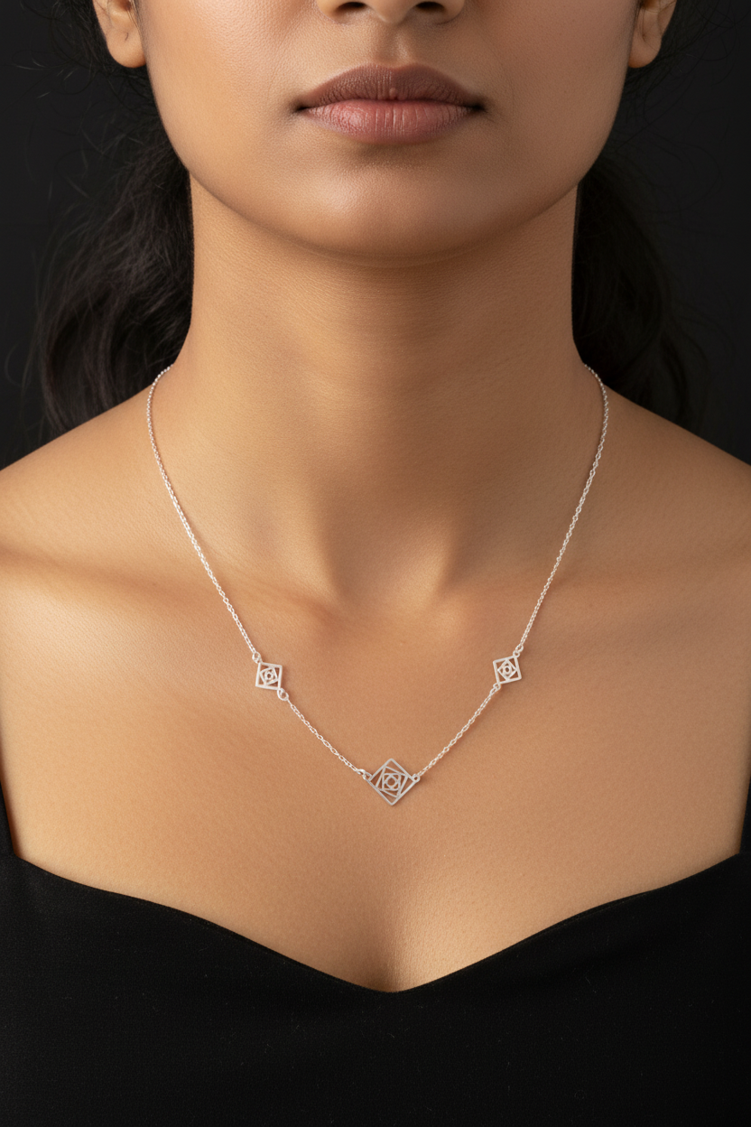 Silver necklace with geometric pendants on a black background