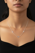 Silver necklace with geometric pendants on a black background