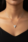 A rhodium-plated silver heart-shaped chain necklace on a white background.