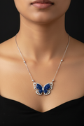 Butterfly necklace with blue gemstones on a black background